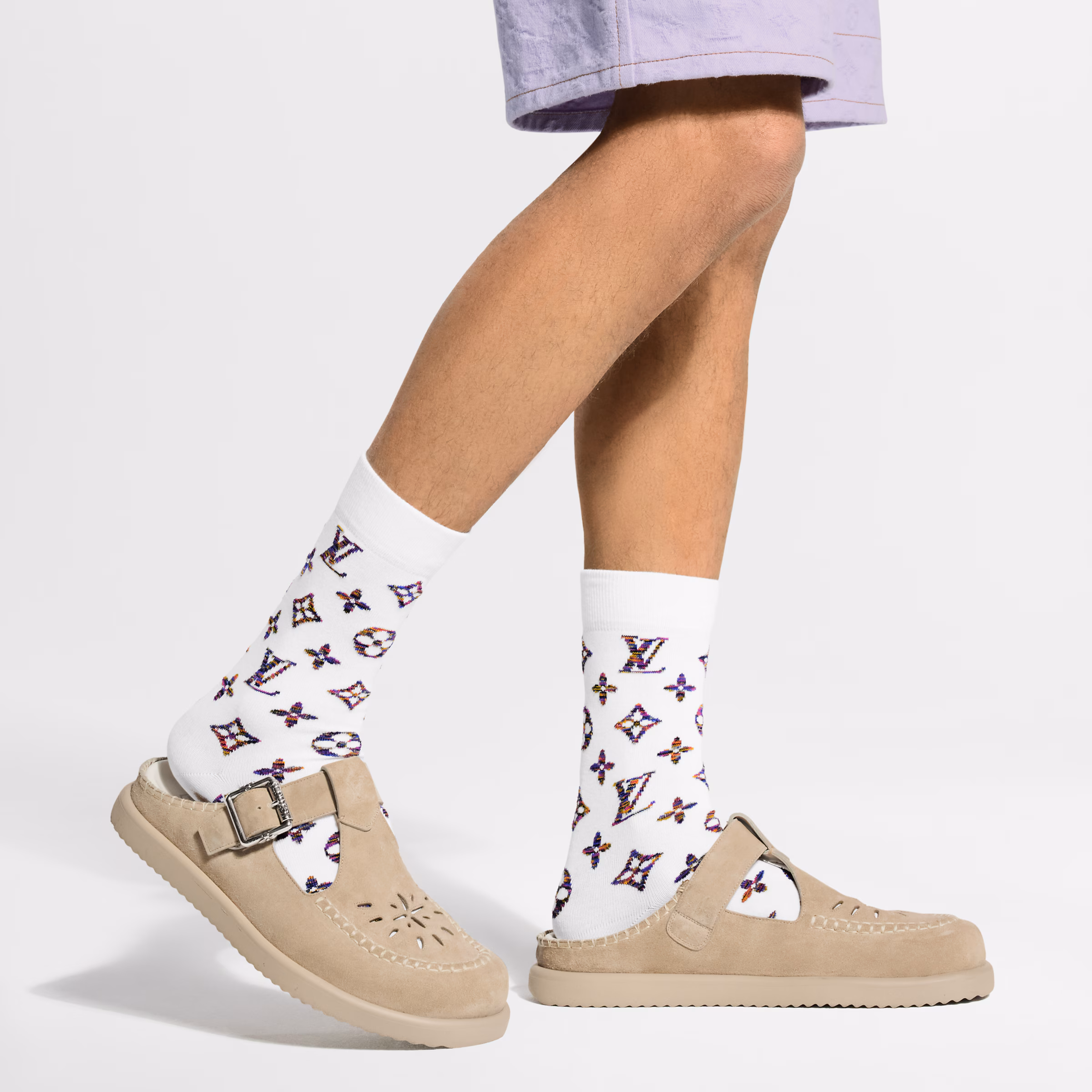 Louis Vuitton LV Easy Mule in gray suede calf leather with adjustable buckle strap, LV Initials, Monogram Flower buckle detail, and lightweight rubber outsole.