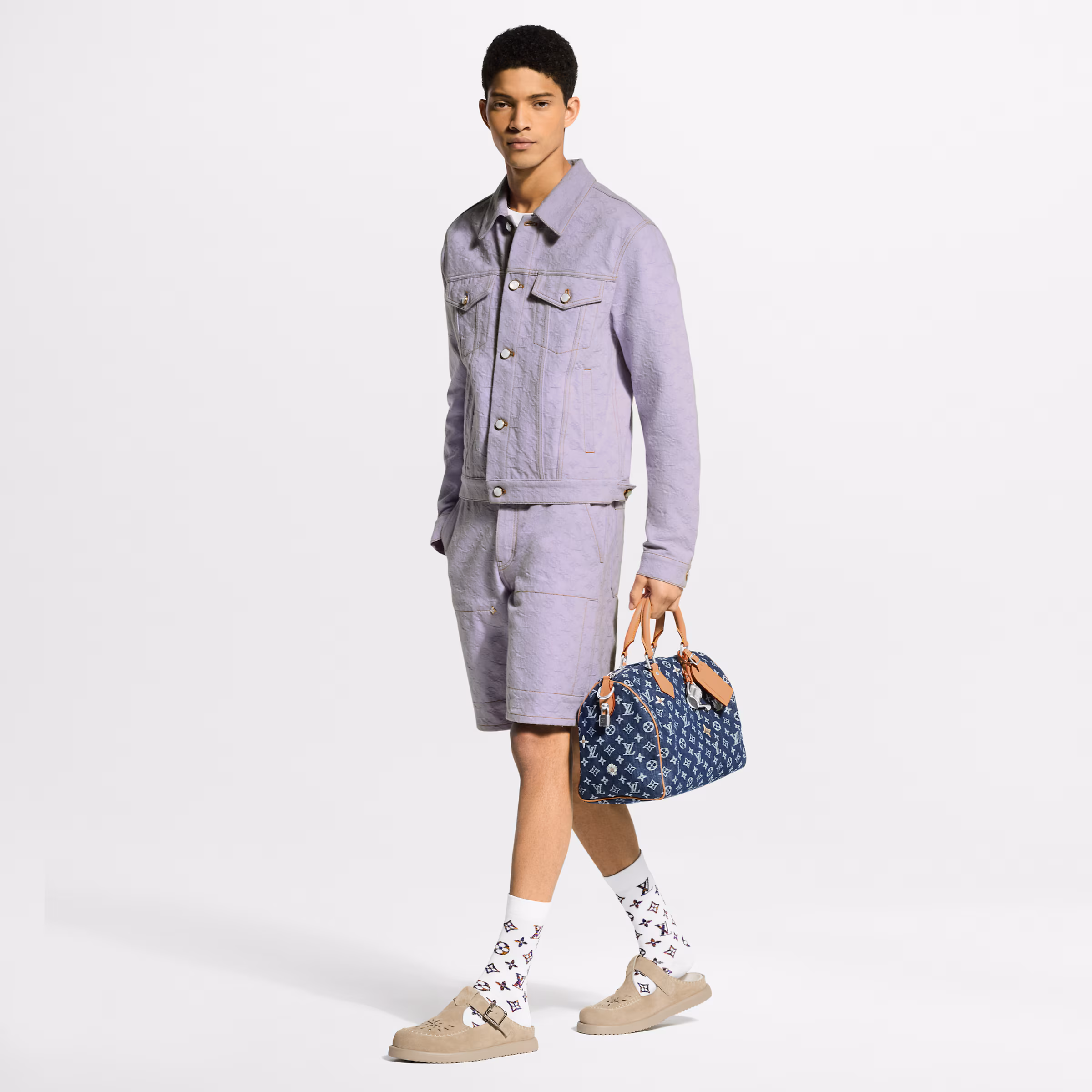 Louis Vuitton LV Easy Mule in gray suede calf leather with adjustable buckle strap, LV Initials, Monogram Flower buckle detail, and lightweight rubber outsole.