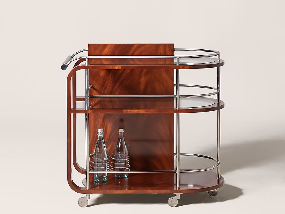 Ralph Lauren Home Duke Bar Cart with polished stainless steel frame, mahogany handle, glass shelves, casters, and bottle storage for a luxury home bar.