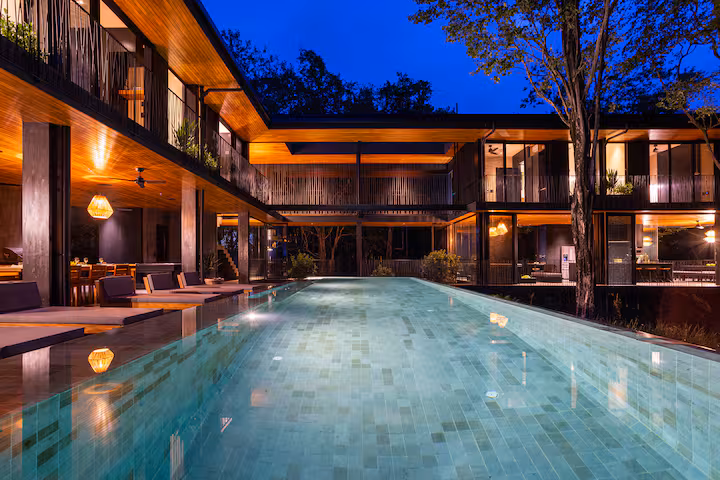 Casa Perla Negra villa in Puerto Carrillo Costa Rica with dark modern architecture, forest surroundings, Pacific views, and an infinity pool.