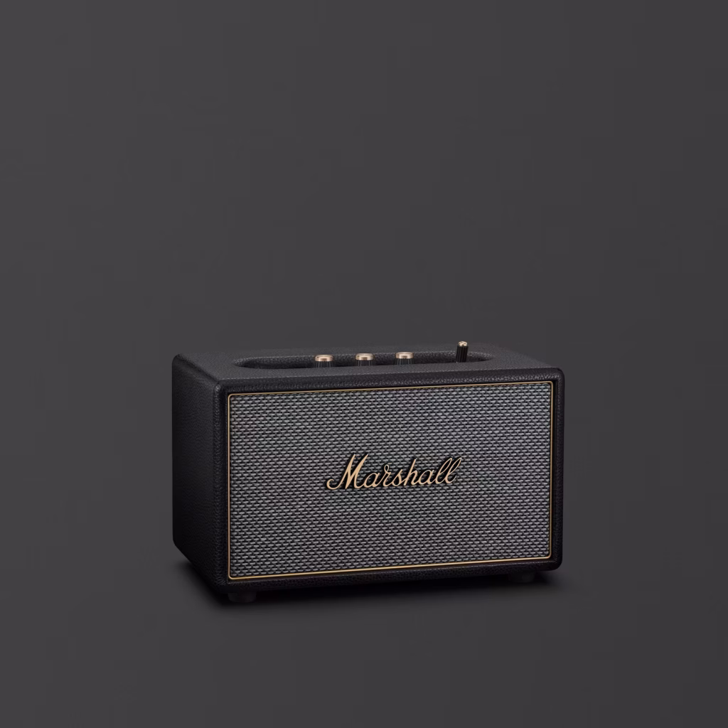 Marshall Acton IV wireless speaker in black with gold accents against a dark background.