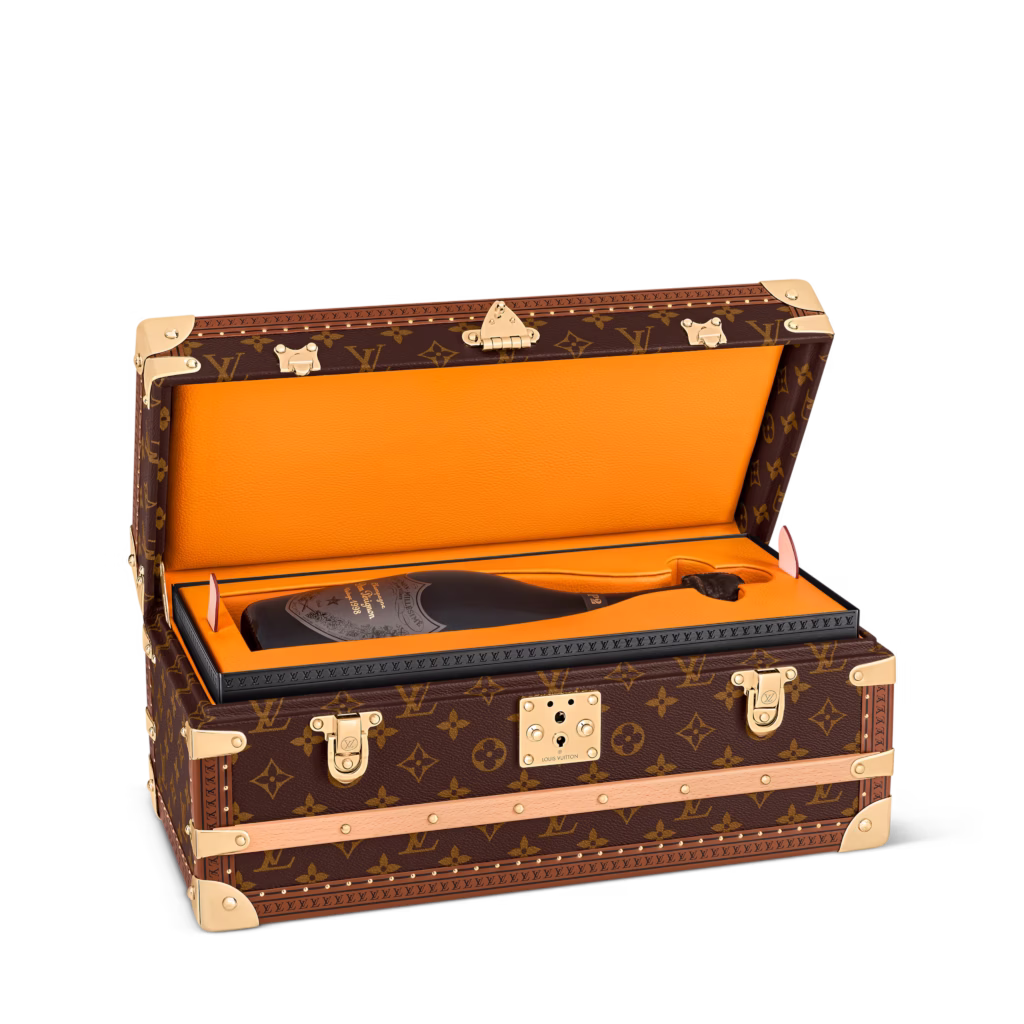 Louis Vuitton champagne trunk in Monogram canvas, shown in product views with orange interior, removable inserts and champagne bottle storage.