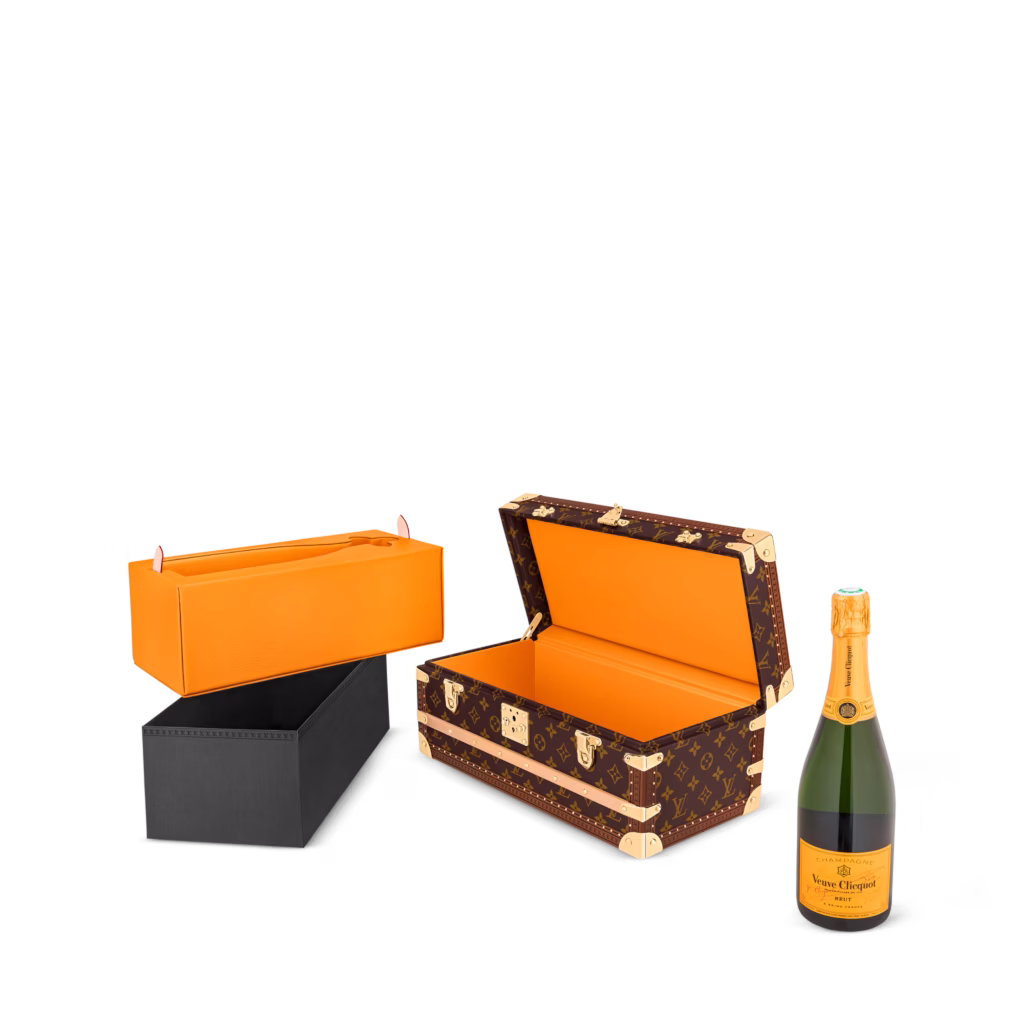 Louis Vuitton champagne trunk in Monogram canvas, shown in product views with orange interior, removable inserts and champagne bottle storage.