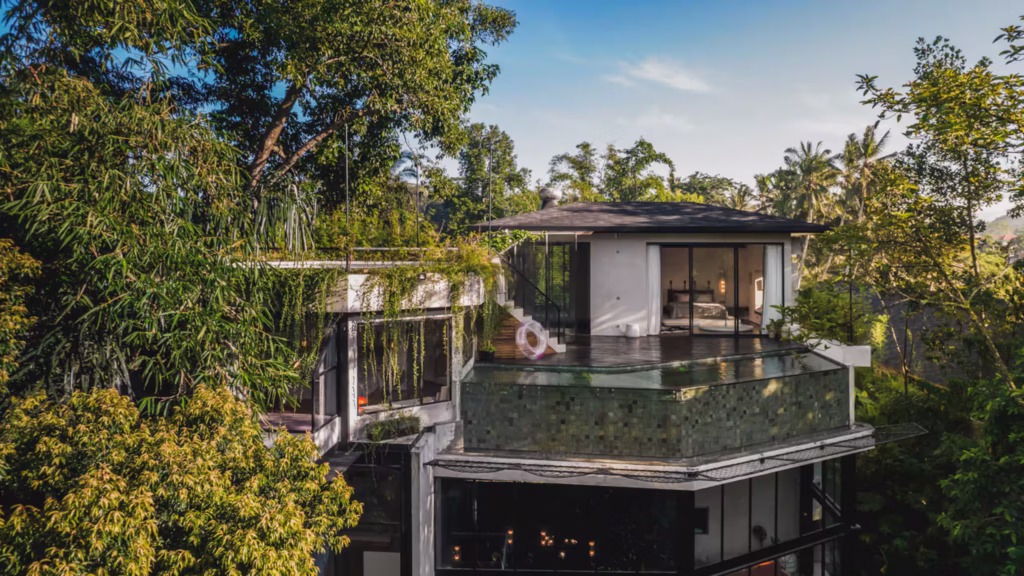 Exterior view of Milliways Bali surrounded by tropical jungle with its elevated swimming pool and private deck.