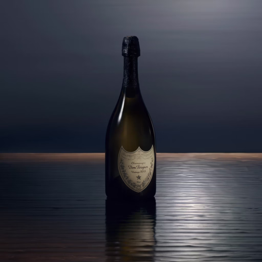 Dom Pérignon Vintage 2015 Champagne bottle on a reflective dark surface