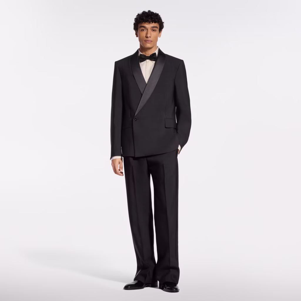 Louis Vuitton model wearing a black tuxedo with shawl lapels and matching formal trousers