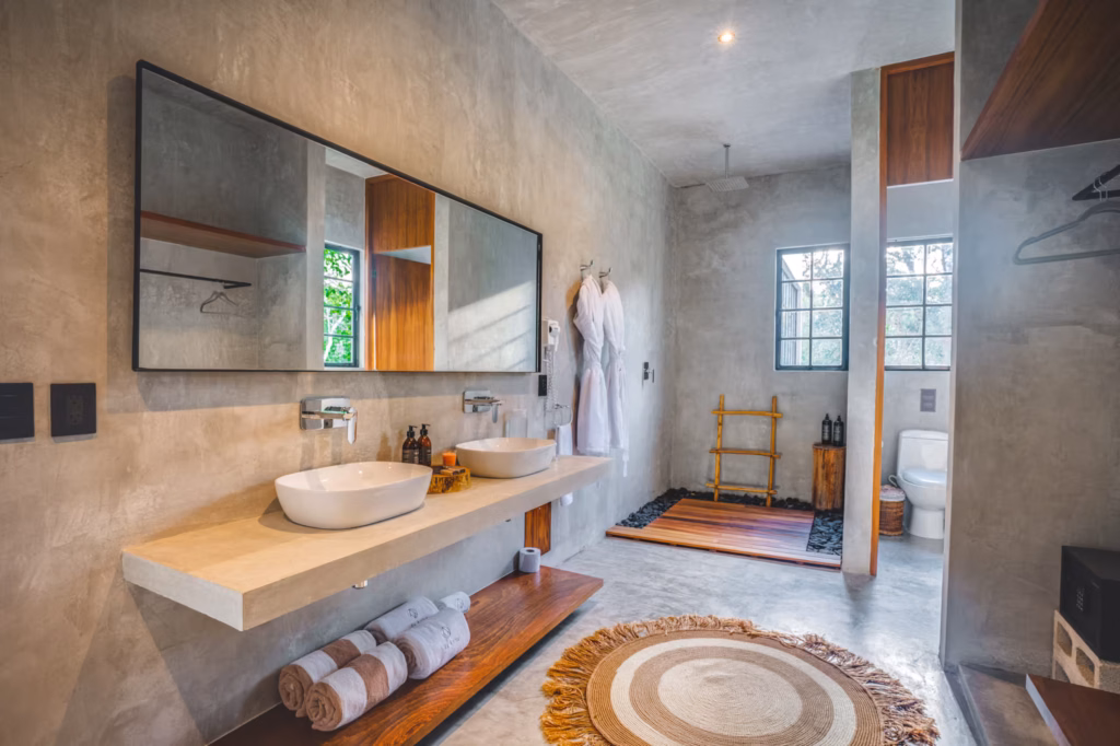 Villa Arthur 600 bathroom featuring dual vessel sinks, a spacious walk-in shower, natural wood details and contemporary design.